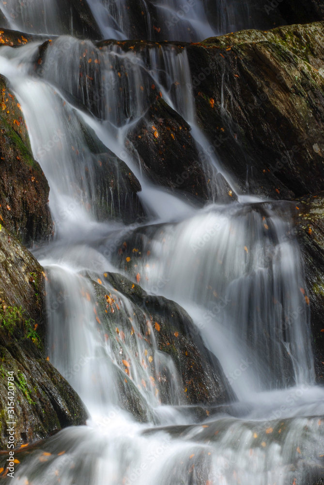 Fototapeta premium New England waterfall. Cascading waterfall in autumn season