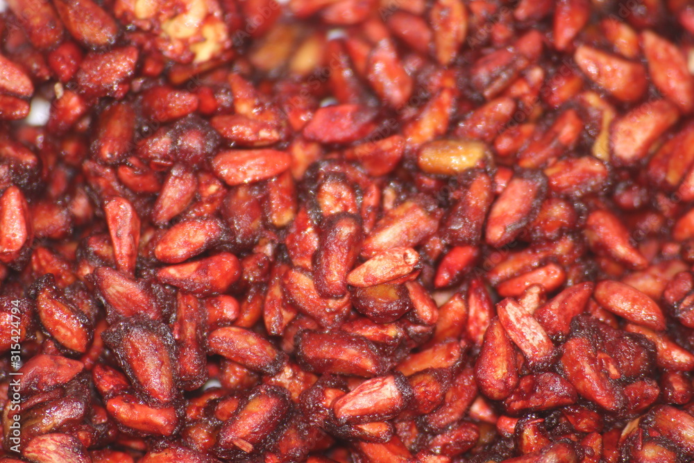 Dry red granat spice seeds macro as background Dry red granat spice seeds macro as background