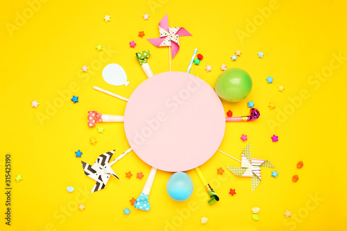 Colorful flat lay composition with various party items on yellow background