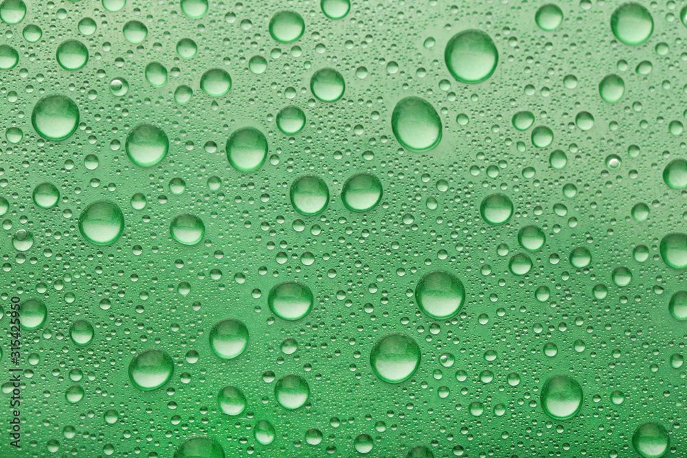 Water drops on green background