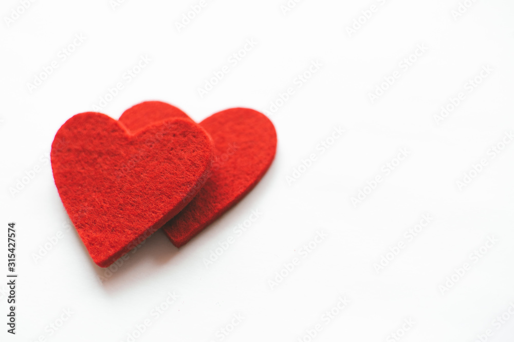 Red felt hearts on a white background. Valentine's Day Red felt hearts on a white background. Valentine's Day