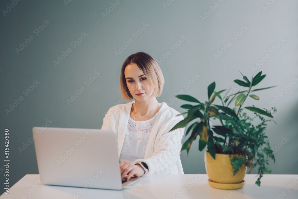 Happy Caucasian business woman working on laptop computer. Freelancer working remotely on Internet from home office. Online dating. Freelance, job, self-employment concept. Happy Caucasian business woman working on laptop computer. Freelancer working remotely on Internet from home office. Online dating. Freelance, job, self-employment concept.