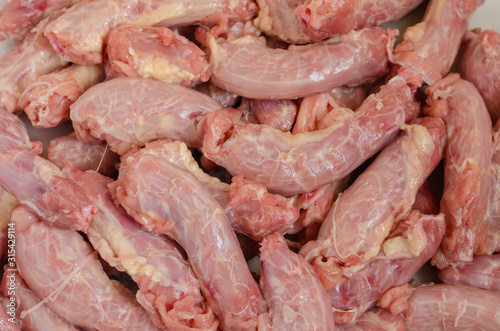 Close-up of a set of raw chicken necks.