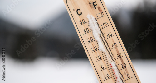 Wooden thermometer in the winter. 