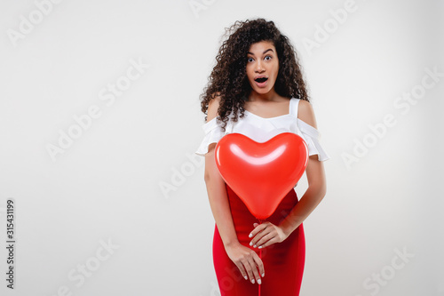 black woman with red heart shaped balloon isolated on white background