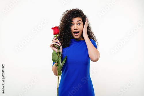 black woman with red rose wearing blue dress isolated over white background