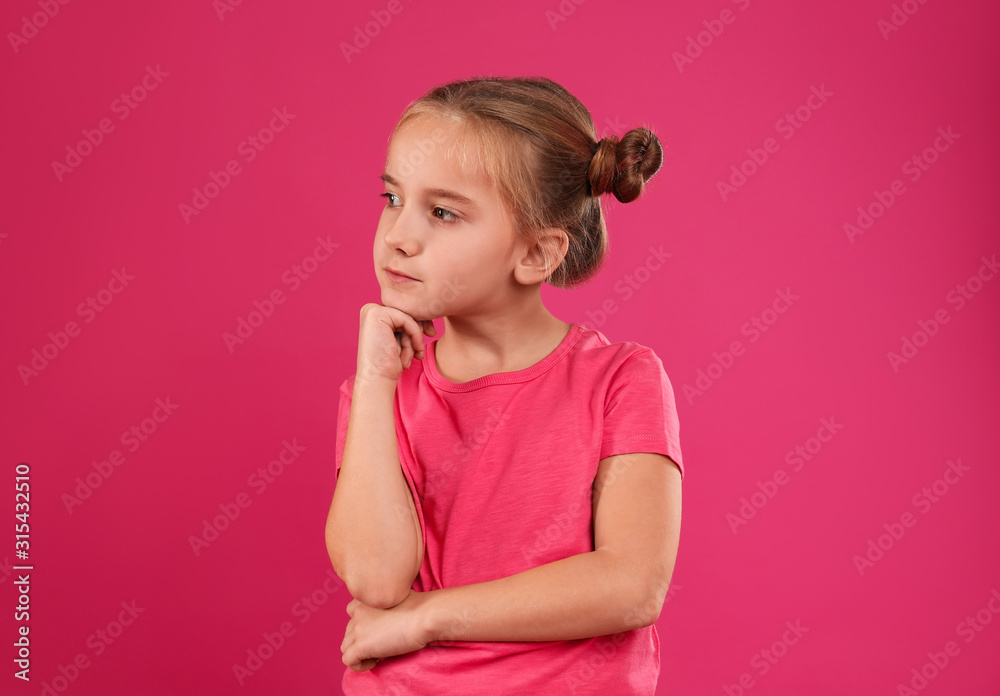 Cute little girl posing on pink background Cute little girl posing on pink background