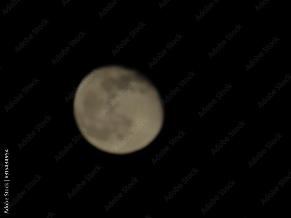 Fototapeta premium Moon With Clouds In The Night Sky. Concept of a spooky theme and mystery.