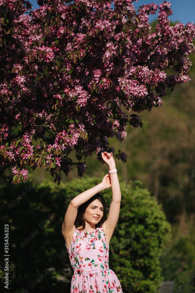Elegant woman in beautiful dress stand outside. Gorgeous model with make up and hairstyle Elegant woman in beautiful dress stand outside. Gorgeous model with make up and hairstyle