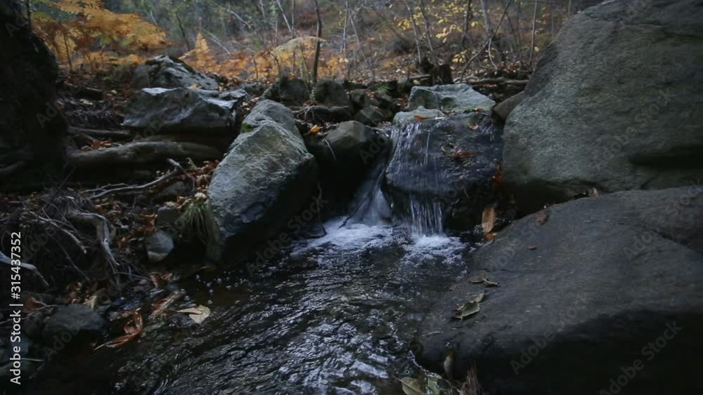 Waterfall on a mountain river in autumn forest Waterfall on a mountain river in autumn forest
