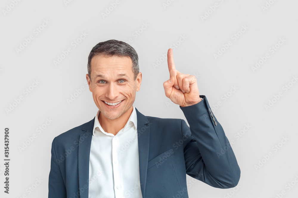 Freestyle. Mature businessman standing isolated on white pointing up idea smiling happy Freestyle. Mature businessman standing isolated on white pointing up idea smiling happy