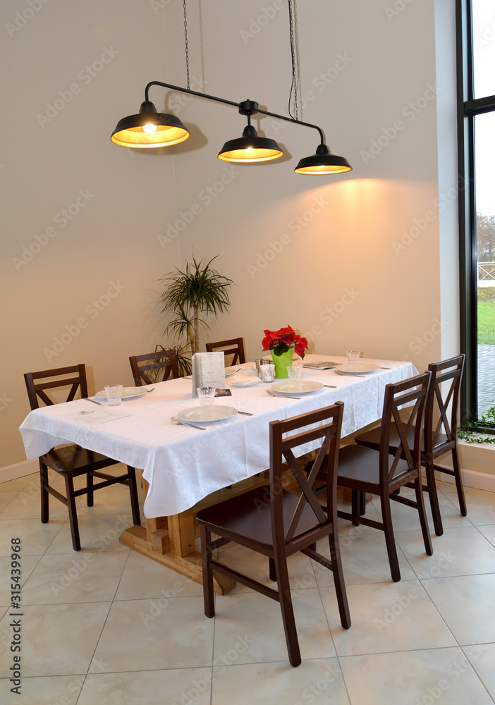 A fragment of the interior of a cafe with a table for six people A fragment of the interior of a cafe with a table for six people