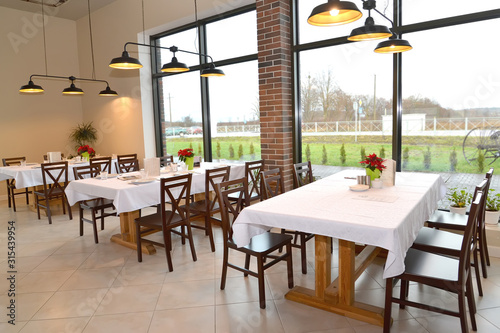 Cafe interior with tables for six and pendant lights photo