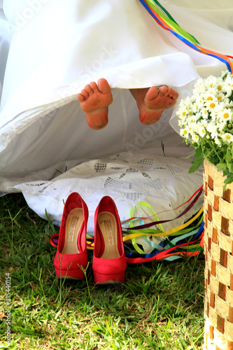  feet and bride's shoes and bouquet