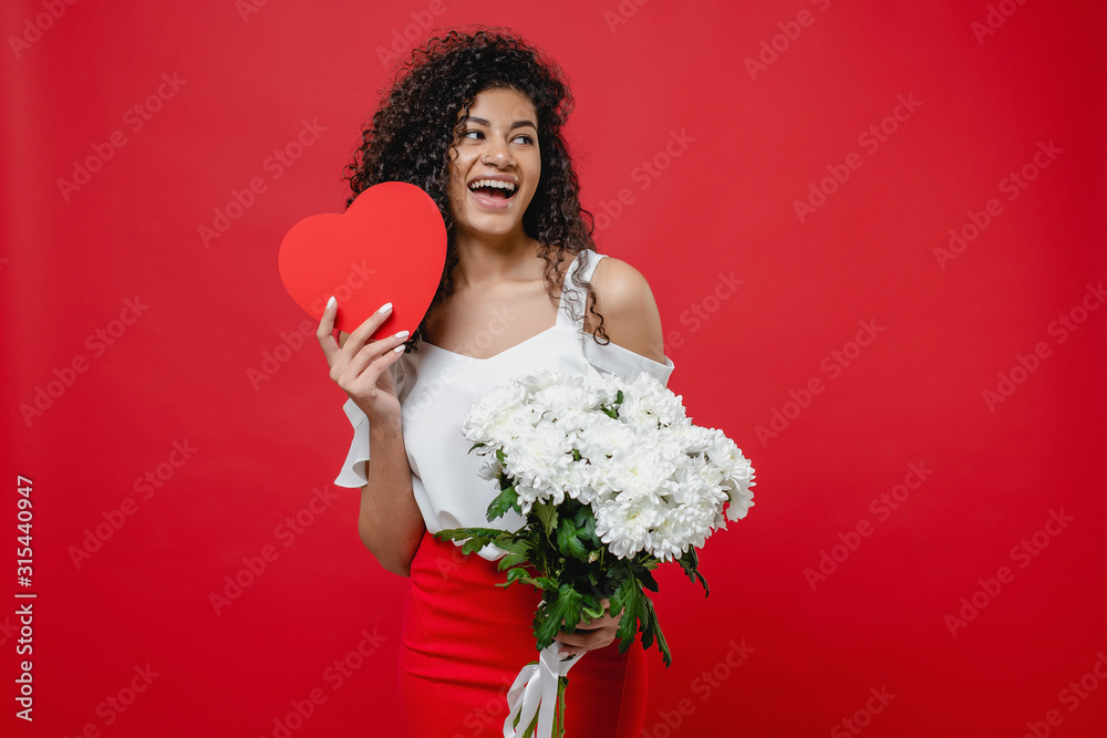 black woman with heart shaped valentine card and bouquet of white flowers isolated on red black woman with heart shaped valentine card and bouquet of white flowers isolated on red