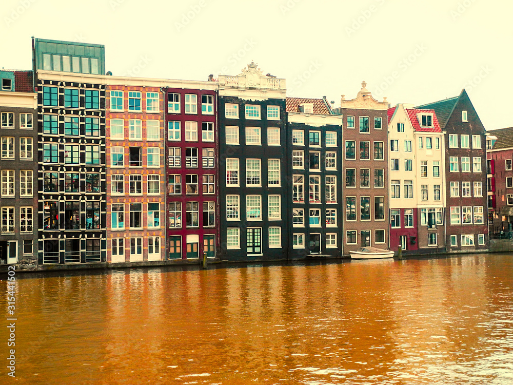 Amsterdam canal, Netherlands. Old beautiful buildings, Amstel river. 