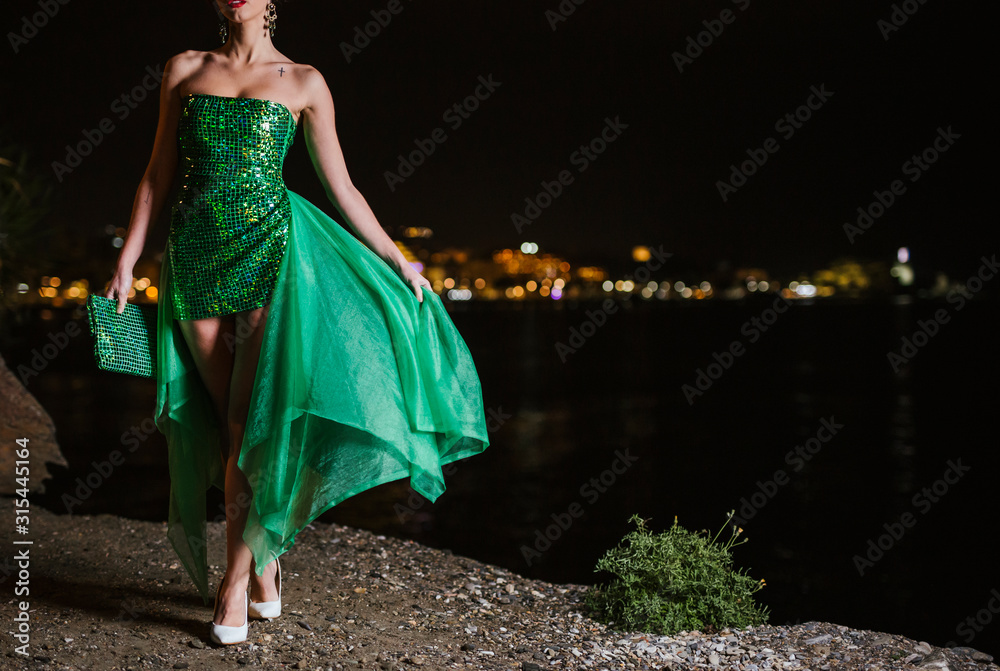 Obraz premium young girl posing with her car and have a nice green dress