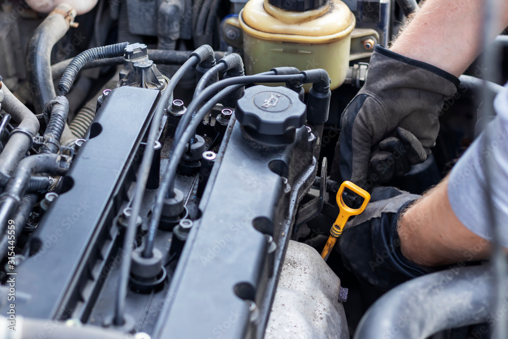 Fototapeta premium A man repairs a car himself