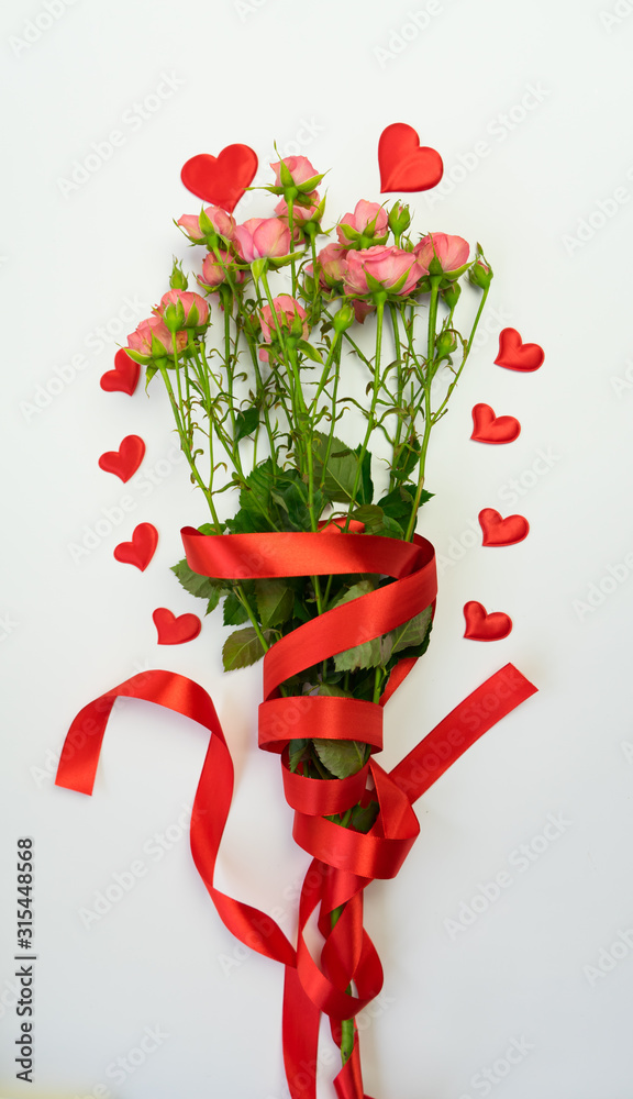 Close up on white background with pink rose and heart on white background Close up on white background with pink rose and heart on white background