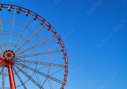 Part of ferris wheel with blue sky background