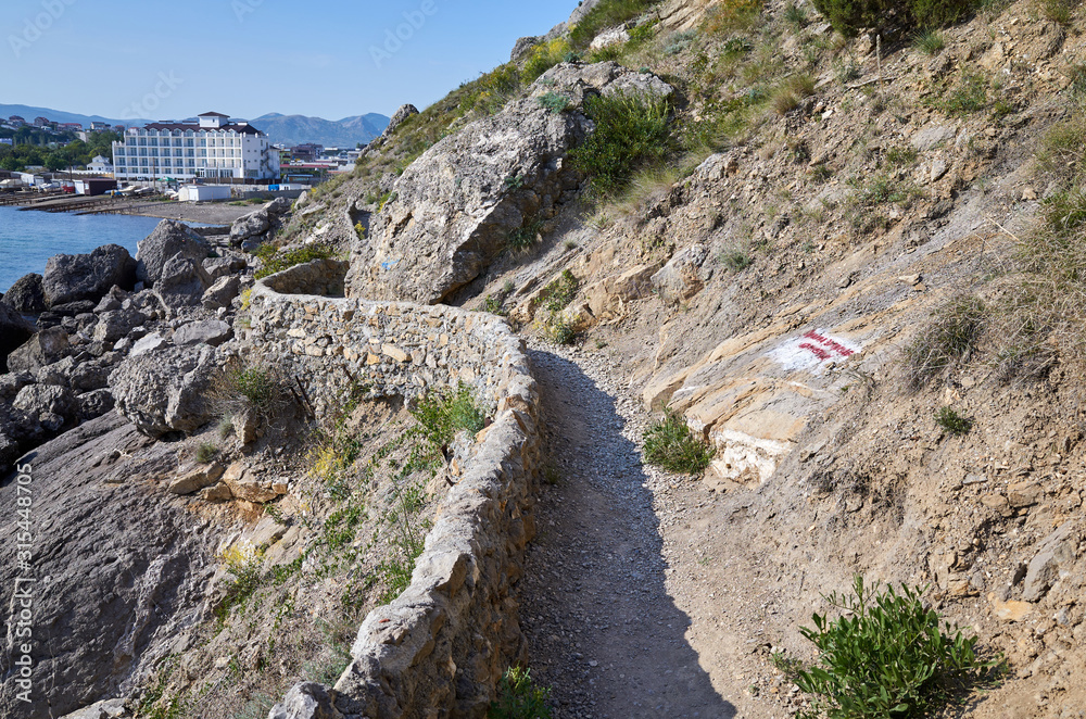 The rocky coast of the Black Sea on Mount Alchak. Walking path for walks, Crimea