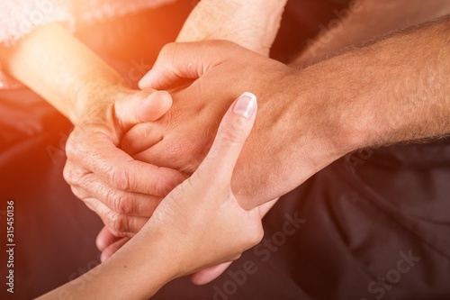 Caregiver, carer hand holding hand man