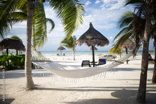 tropical beach with chairs and umbrellas
