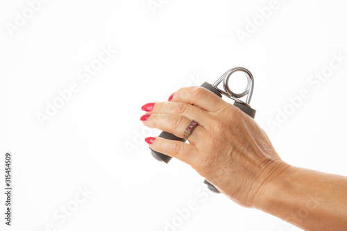 female left hand exercising with a hand griper isolated in white background
