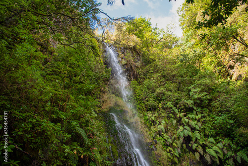 Waterfall beside the hiking trail on the Levada Caldeirao Verde near Santana on the island of Madeira, Portugal.