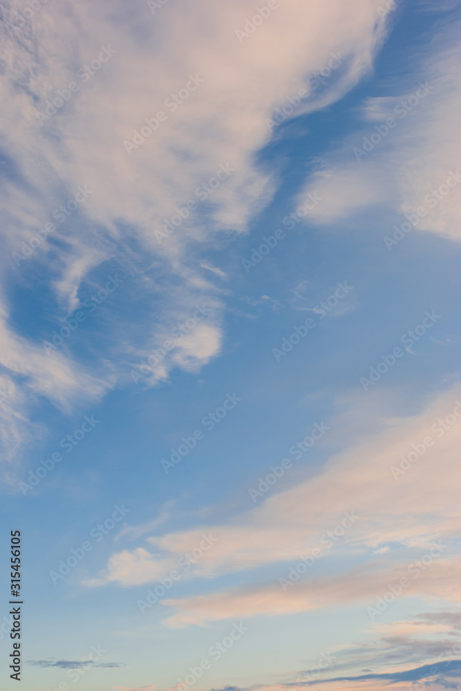 Cirrus clouds against the blue sky in summer