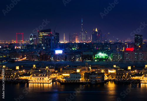 Panoramic view of Dubai cityscape and the Dubai creek at night