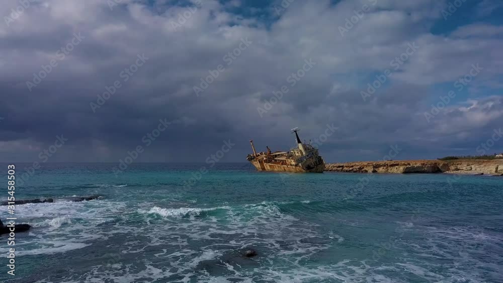 Flight over the sea and ship aground. Cargo vessel Edro III shipwrecked near rocky coast in Mediterranean sea at Paphos, Cyprus. 4K Flight over the sea and ship aground. Cargo vessel Edro III shipwrecked near rocky coast in Mediterranean sea at Paphos, Cyprus. 4K