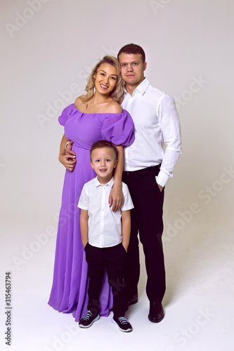 family in the Studio mom in a purple long dress with her son and husband