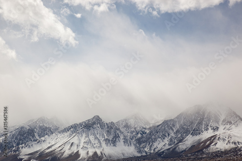 Winter landscape of the Eastern Sierra Nevada Mountains framed by clouds, California, USA