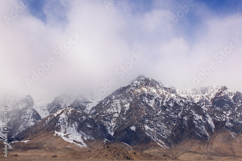 Winter landscape of the Eastern Sierra Nevada Mountains framed by clouds, California, USA © Dean Pennala