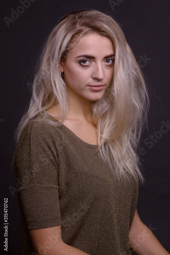 Studio portrait of young beautiful girl on a black background