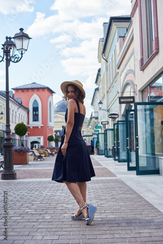 Summer sunny lifestyle fashion portrait of young stylish hipster woman walking on the street, wearing cute trendy outfit, © Elena Kharichkina