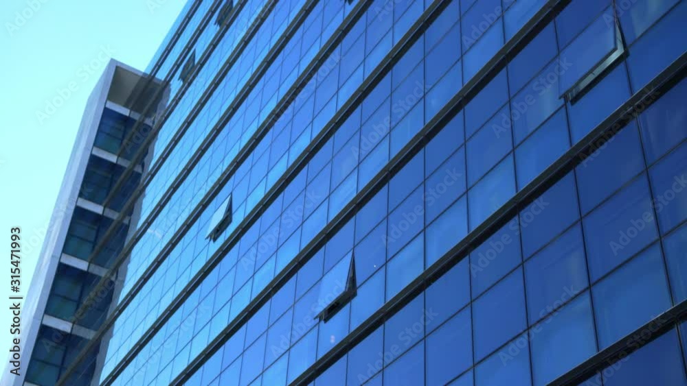 glass facade of an office building in sunny weather glass facade of an office building in sunny weather