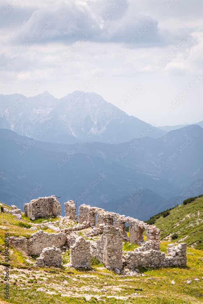 Mountain Hochobir with ruin of hut and Kamnik–Savinja Alps