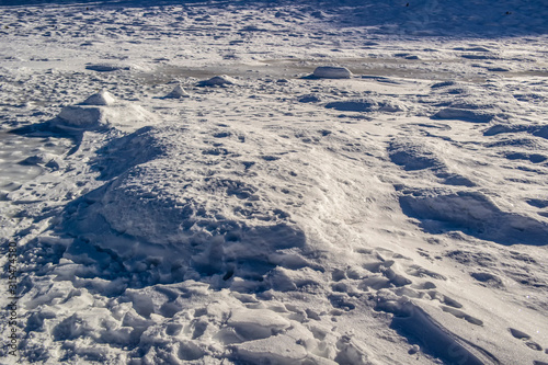 Background of white snow piles of frozen high mountain