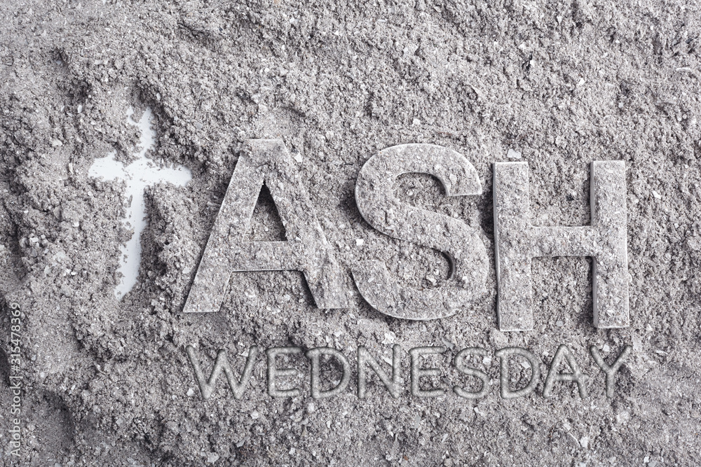 Ash wednesday word written in ash and christian cross symbol as a religion concept Ash wednesday word written in ash and christian cross symbol as a religion concept
