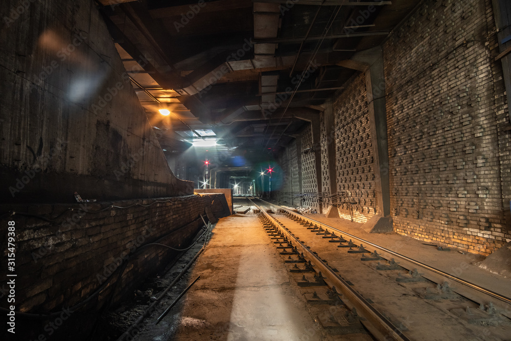 Big empty railway tunnel with many tracks near the underground railway