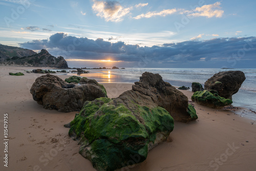 Praia do amado beach at sunset in Costa Vicentina, Portugal