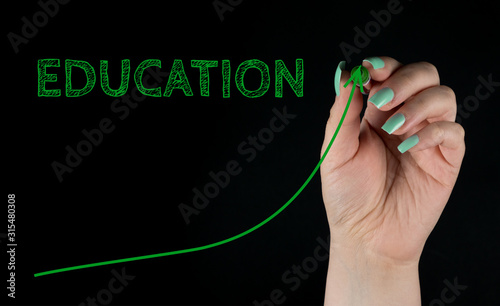 Education quality Increasing Graph Concept, handwritten with Green marker on black background