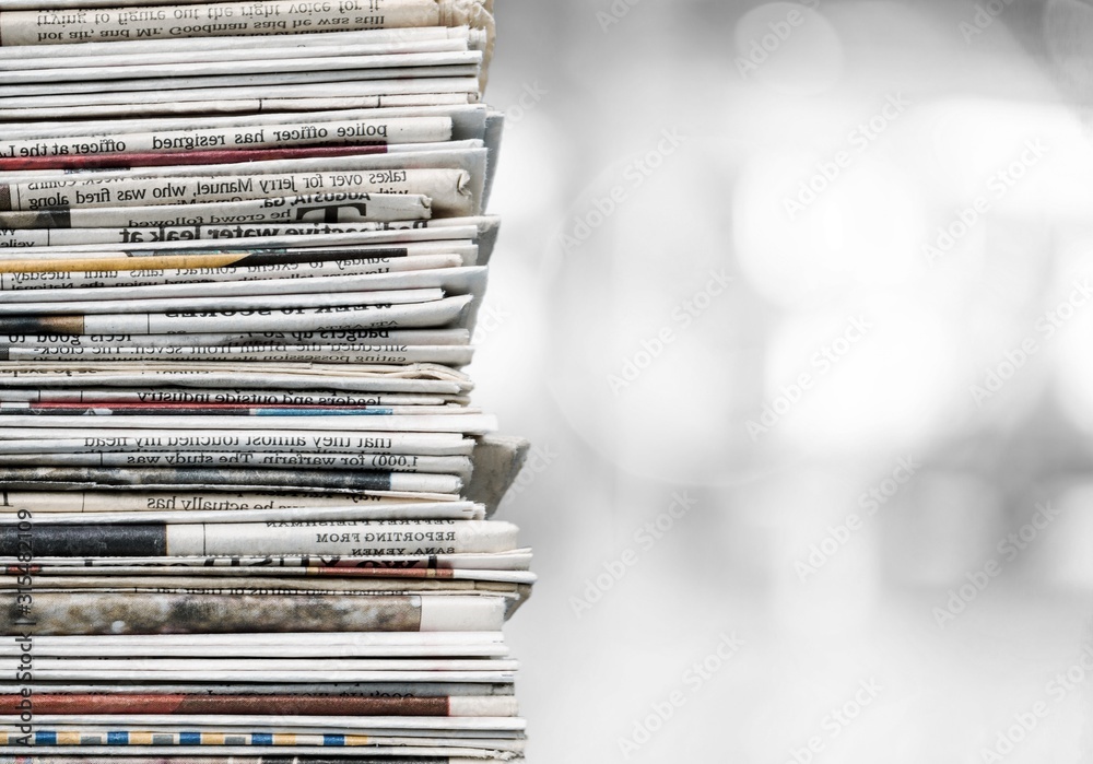 Pile of newspapers on a bokeh background Pile of newspapers on a bokeh background