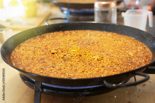 Paella pan with traditional Spanish food usually prepared with rice, meat, seafood. Horizontal orientation