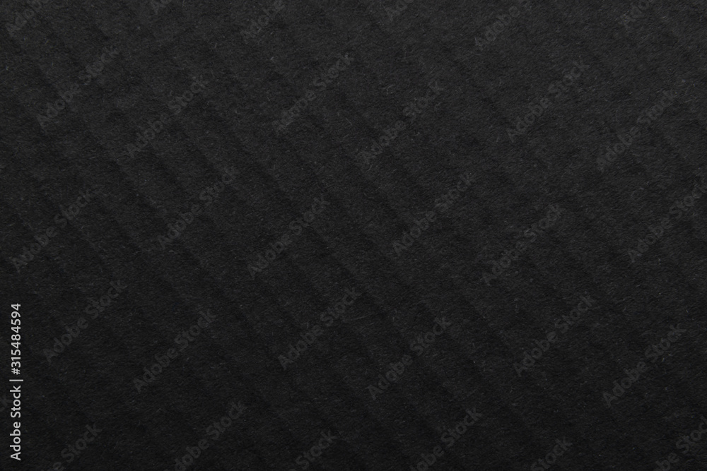 Fototapeta premium The surface of black paper texture, craft paper cardboard for a background close up