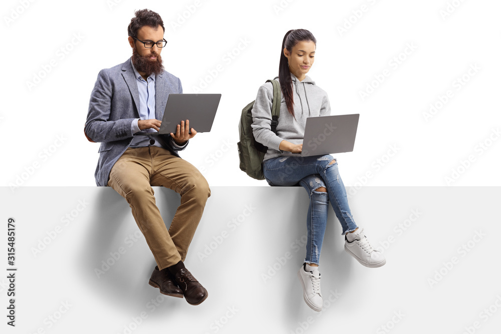 Male teacher and a female student with laptop computers sitting on a panel - obrazy, fototapety, plakaty 