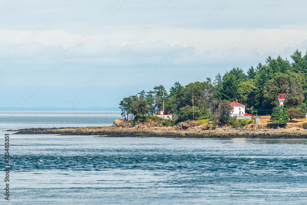 Naklejka premium View over inlet, ocean and island with boat and mountains in beautiful British Columbia. Canada.