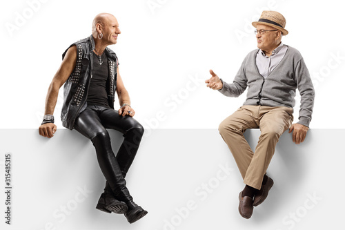 Punker talking to an elderly manand sitting on a panel photo